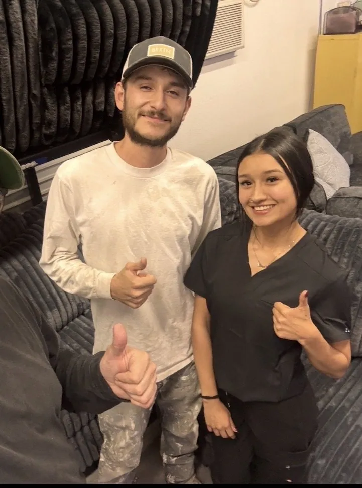 Couple giving a thumbs up with a sectional at our Elk Grove showroom