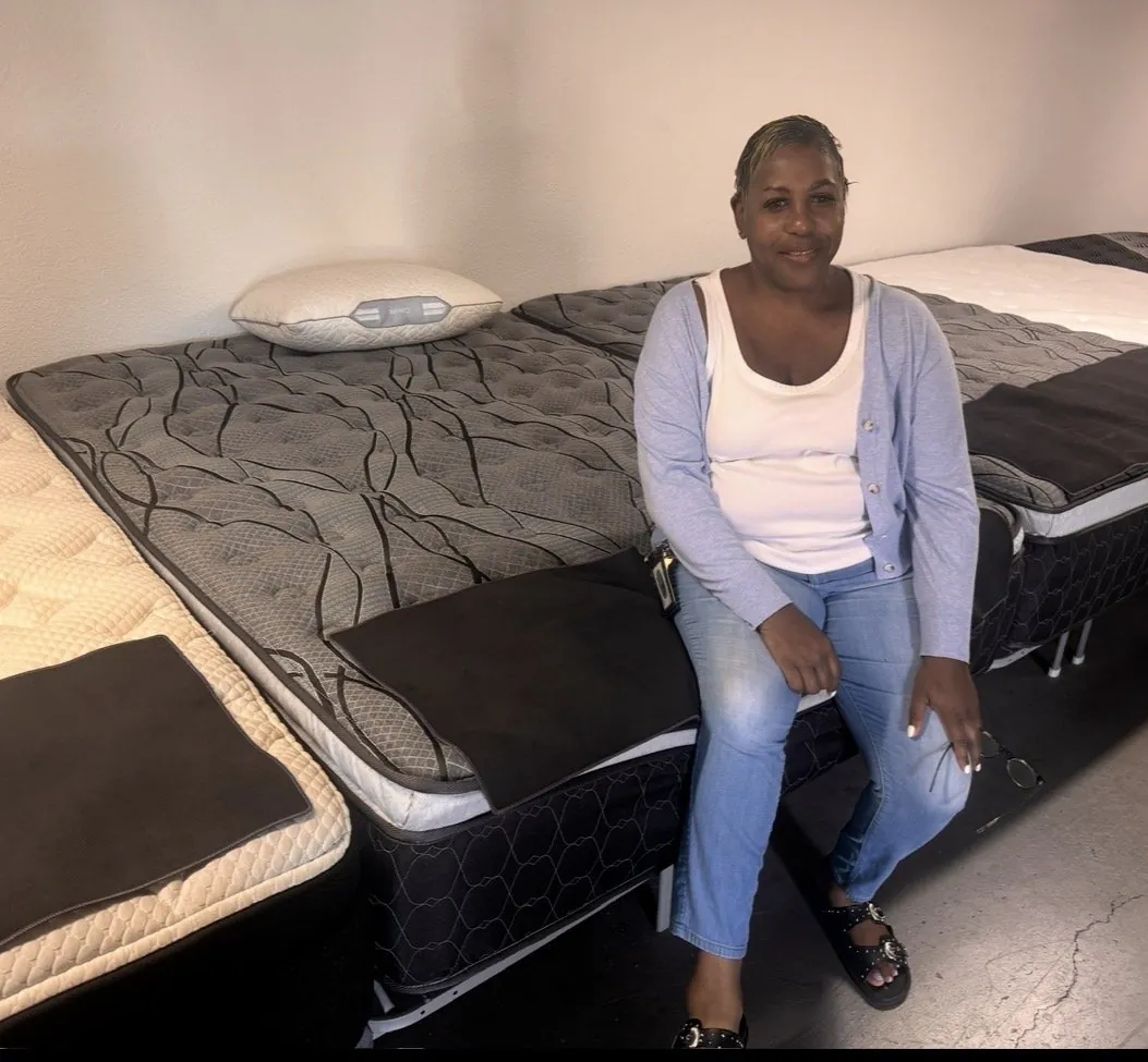 Customer with a new mattress set at our Elk Grove showroom