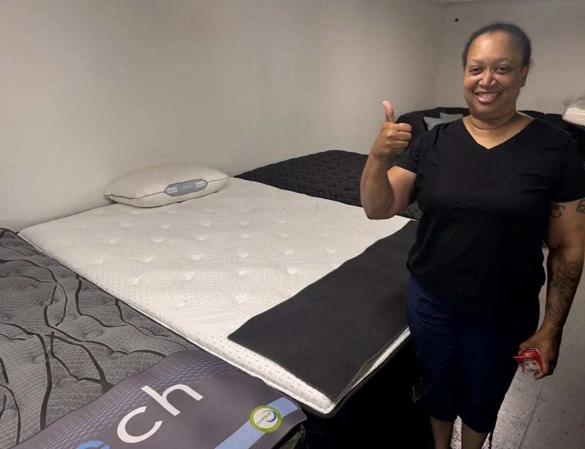 Customer with a new mattress at our Elk Grove showroom