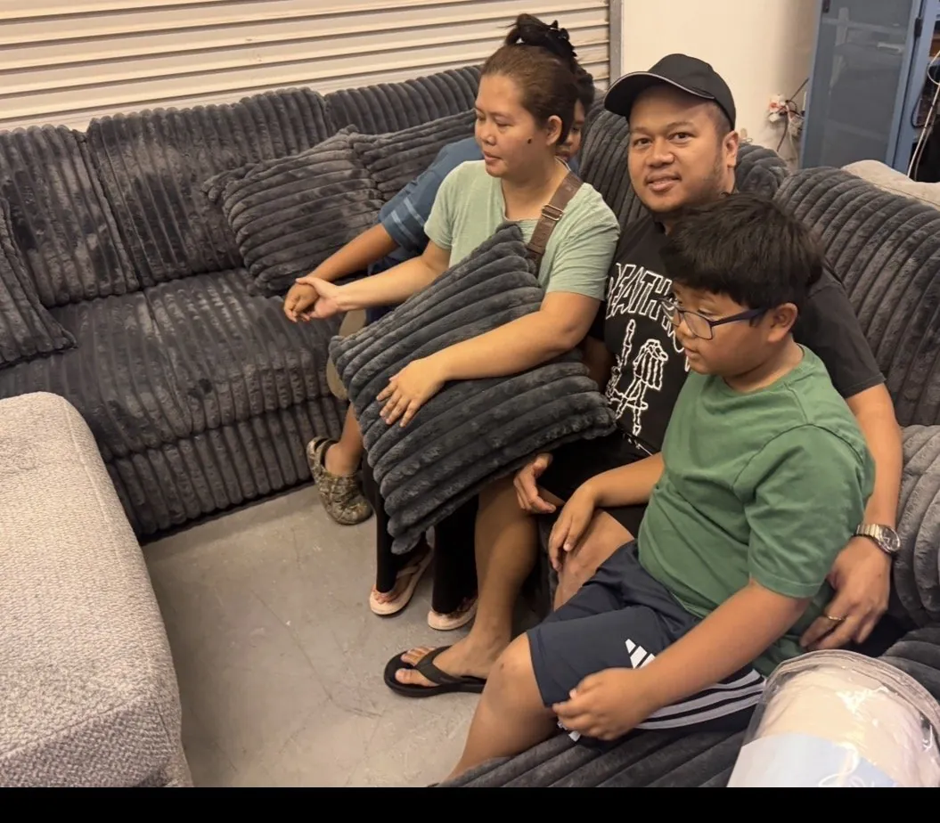 Family on a new sectional at our Elk Grove showroom